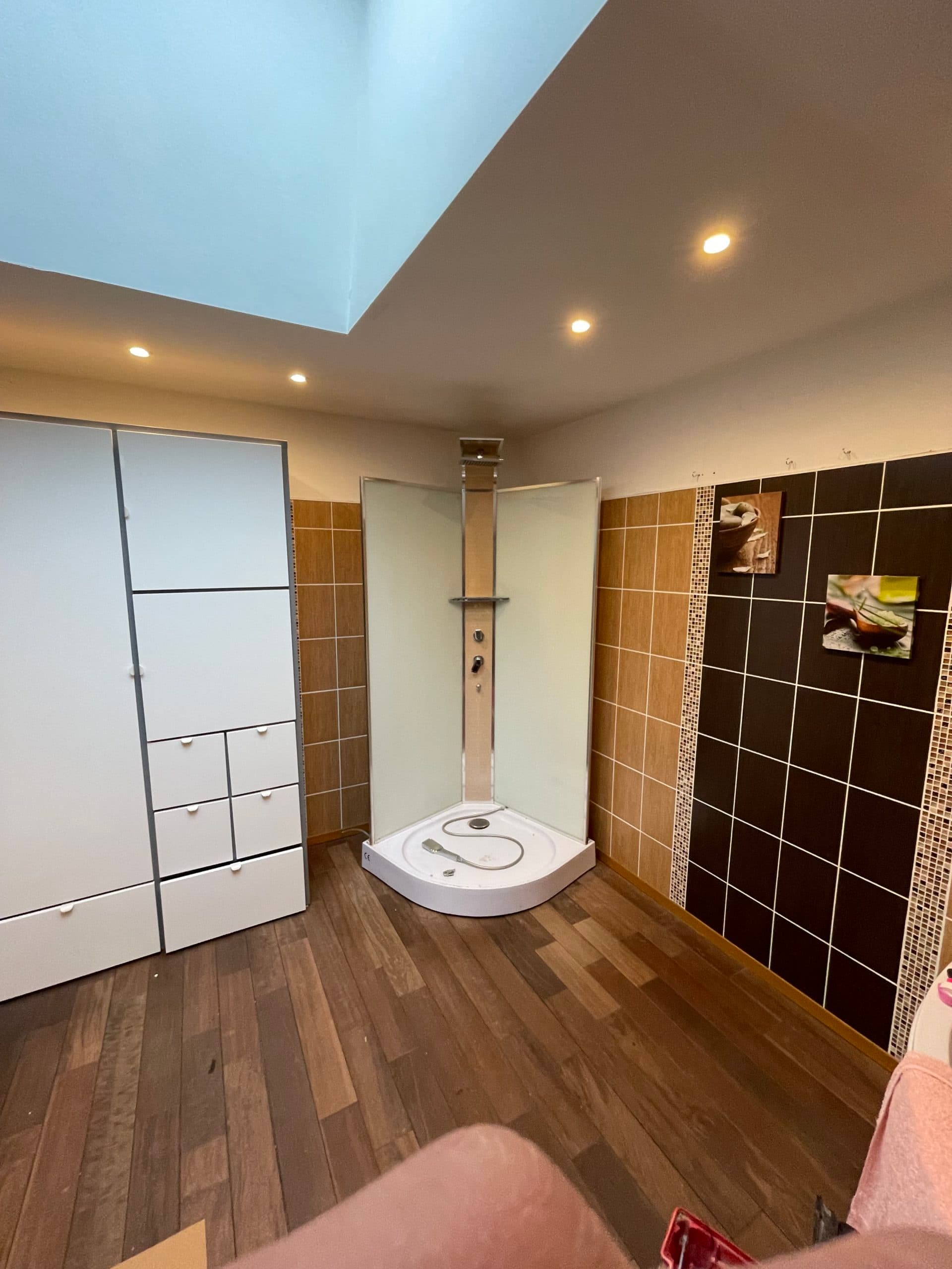 Salle de bain aménagée sous combles avec puits de lumière